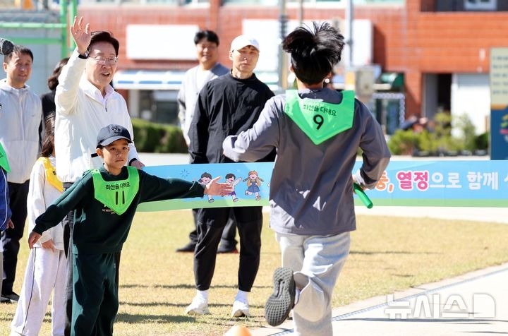 [Iksan=Newsis] Phóng viên Kim Jin-ah = Tổng thống Lee Jae-myung đang cầm dây đích tại đường chạy tiếp sức và cổ vũ các học sinh tại Lễ hội thể thao Trường hạnh phúc mùa thu diễn ra tại Trường tiểu học Wanggung, Iksan, Tỉnh Bắc Jeolla vào ngày 22. 2026.10.22. bluesoda@newsis.com